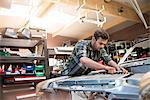 Mechanic fixing car engine in auto repair shop