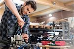 Mechanic fixing car engine in auto repair shop