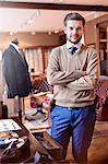 Portrait confident tailor in menswear shop