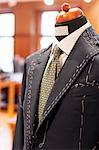 Close up tailored suit on dressmakers model in menswear shop