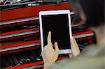 Mechanic using digital tablet at the repair garage