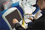Businessman using self service check-in machine at airport