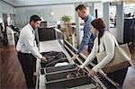 Woman putting shoes into tray for security check at airport