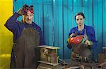 Portrait of male and female welder standing together in workshop