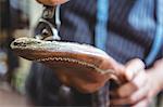 Close-up of shoemaker holding a shoe in workshop