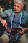 Shoemaker repairing a shoe in workshop