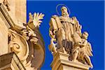 Ornate detail of mouldings and statue on the San Giuseppe Church against blue sky in Ragusa in Sicily, Italy