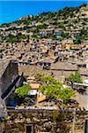 Overlooking private garden and tiled rooftops of homes on mountain side in historical Modica, Sicily, Italy