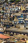 Overview of rooftops of compacted homes made of stone in historical Modica in Sicily, Italy