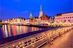 Night view of typical houses and the cathedral reflected in River Trave, Lubeck, Schleswig Holstein, Germany, Europe