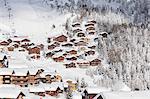 Snowy woods frame the typical alpine village and ski resort, Bettmeralp, district of Raron, canton of Valais, Switzerland, Europe