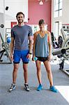 Portrait of a young couple standing in a fitness club