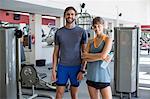 Portrait of a happy couple young standing in fitness club