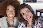 Portrait of happy female friends having fun in cafe