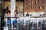 Female friends having coffee together at cafe