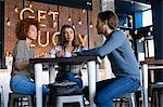 Friends talking with coffee at cafe table