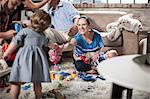 Baby girl playing with parents at home