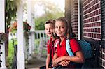 Portrait of twin brother and sister on first day of new school year