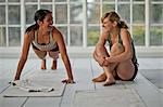 Two young women exercising together.