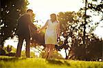 Bride and groom walking hand in hand.