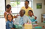 Senior man celebrating his birthday with his family.