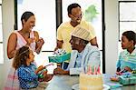 Senior man celebrating his birthday with his family.