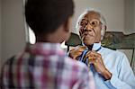 Grandfather tying necktie