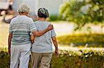 Senior woman walking with her arm around her friend.