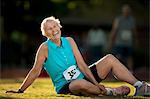 Portrait of a smiling senior woman resting after competing in a running race.