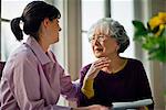 Elderly woman speaking with her doctor.