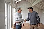 Builder shaking hands with client.