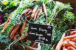 Organic carrots being sold in a farm shop.