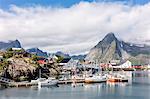 Fishing village and harbour framed by peaks and sea, Hamnoy, Moskenes, Nordland county, Lofoten Islands, Arctic, Northern Norway, Scandinavia, Europe