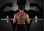 Back of muscular man training with a barbell