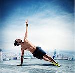 Man in a pilates position above the roof of a building