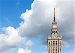 The top of old skyscraper against the cloudy sky. Warsaw symbol.