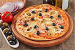 Pizza with tomatoes, squid, shrimp, mussels cheese and olives