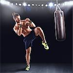 Man is training with the punching bag on gym