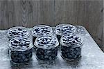 Jar of blueberries fruit compote on wooden table