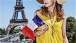 Having fun time near the world famous landmark in Paris. young woman in bright blouse with flag in Paris, France