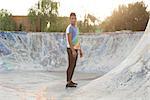 African american young man posing at sunset in a skate park.