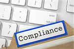 Compliance written on Blue File Card Lays on White PC Keyboard. Closeup View. Blurred Image. 3D Rendering.