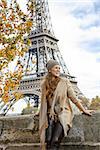 Autumn getaways in Paris. smiling young elegant woman on embankment in Paris, France exploring attractions