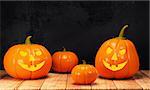 Halloween pumpkin on wooden table on dark background. 3d rendering