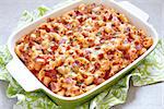 Pasta casserole with bacon, ham, cheese and tomato sauce