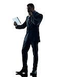 one caucasian business man standing using digital tablet  silhouette isolated on white background