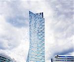 Modern residential skyscraper at cloudy sky. Copy space.