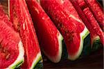 Juicy watermelon slices lying on wooden surface. Close up view.