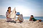 Mother and father with young son at beach.