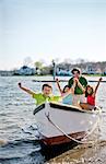 Family at beach with row boat.